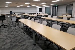 classroom with long desks and desk chairs